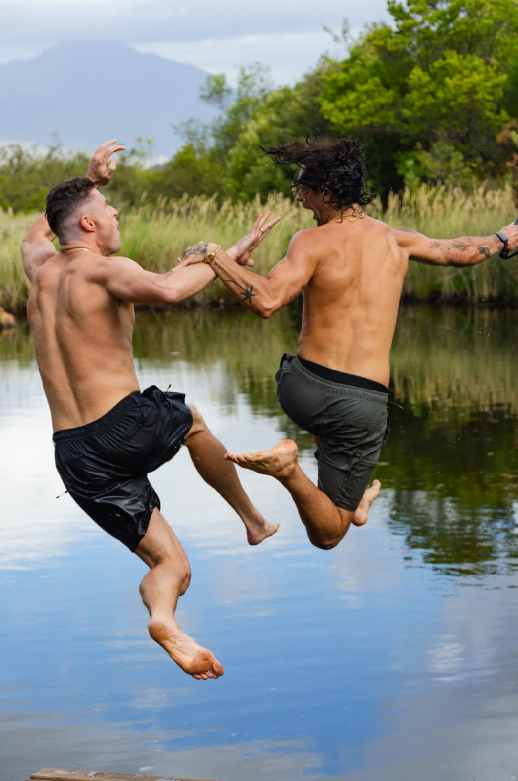 Friends leaping into the dam